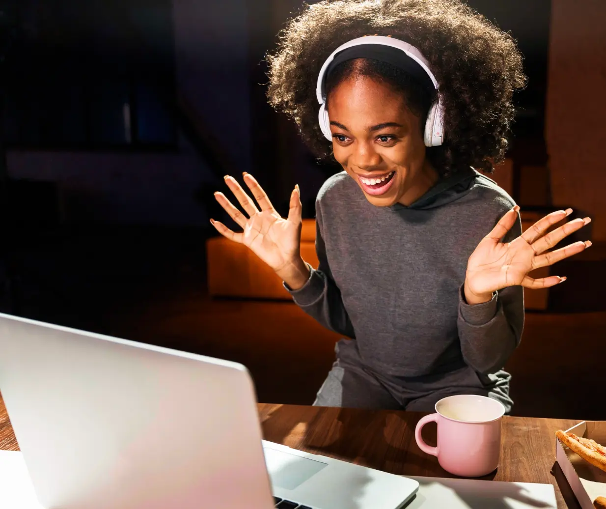 Lady smiling in front of a laptop.